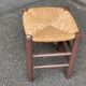 Traditional farmhouse stool in solid wood with straw seat.