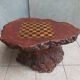 Brutalist chessboard coffee table made from tree stump.