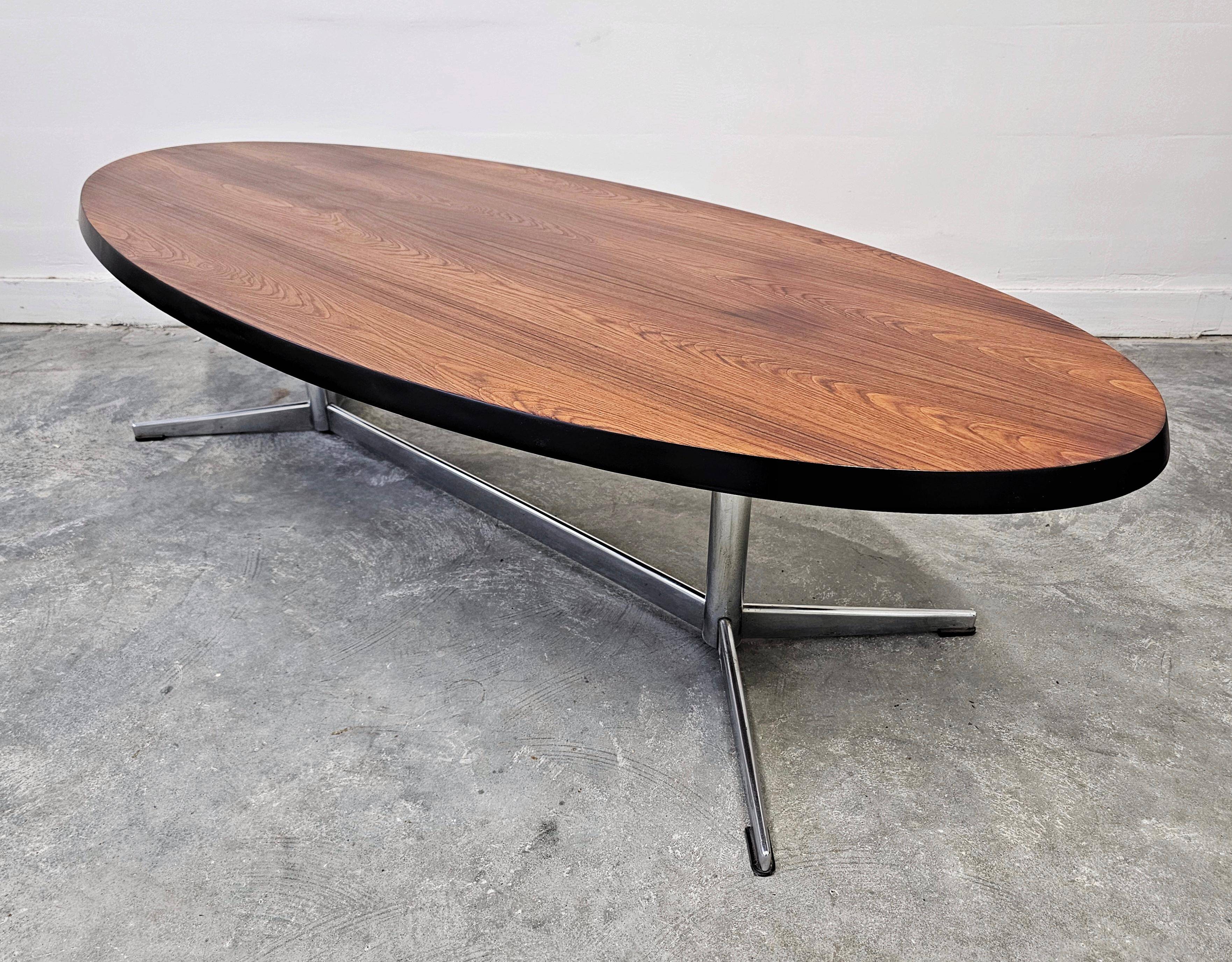 Danish Mid Century Modern oval coffee table with a teak top and chrome legs.