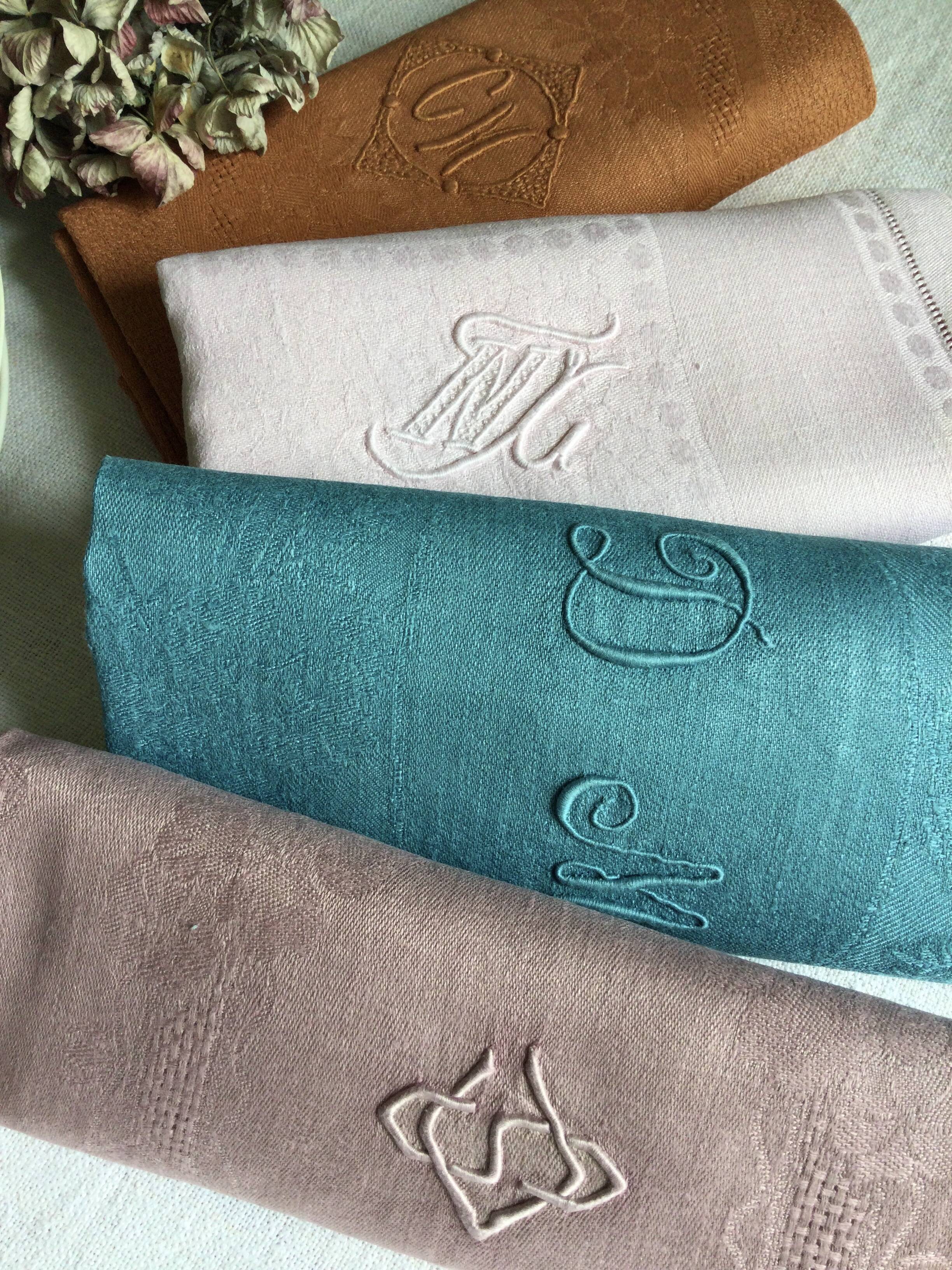 Set of four old damask towels tinted in multiple colors