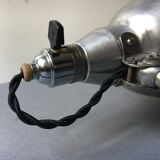 Old industrial lamp has vise 'mazda '.