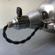 Old industrial lamp has vise 'mazda '.