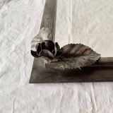 Vintage wall mirror in varnished steel decorated with a rose in relief