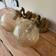 Pair of vintage wall sconces with golden metal swan heads and glass.