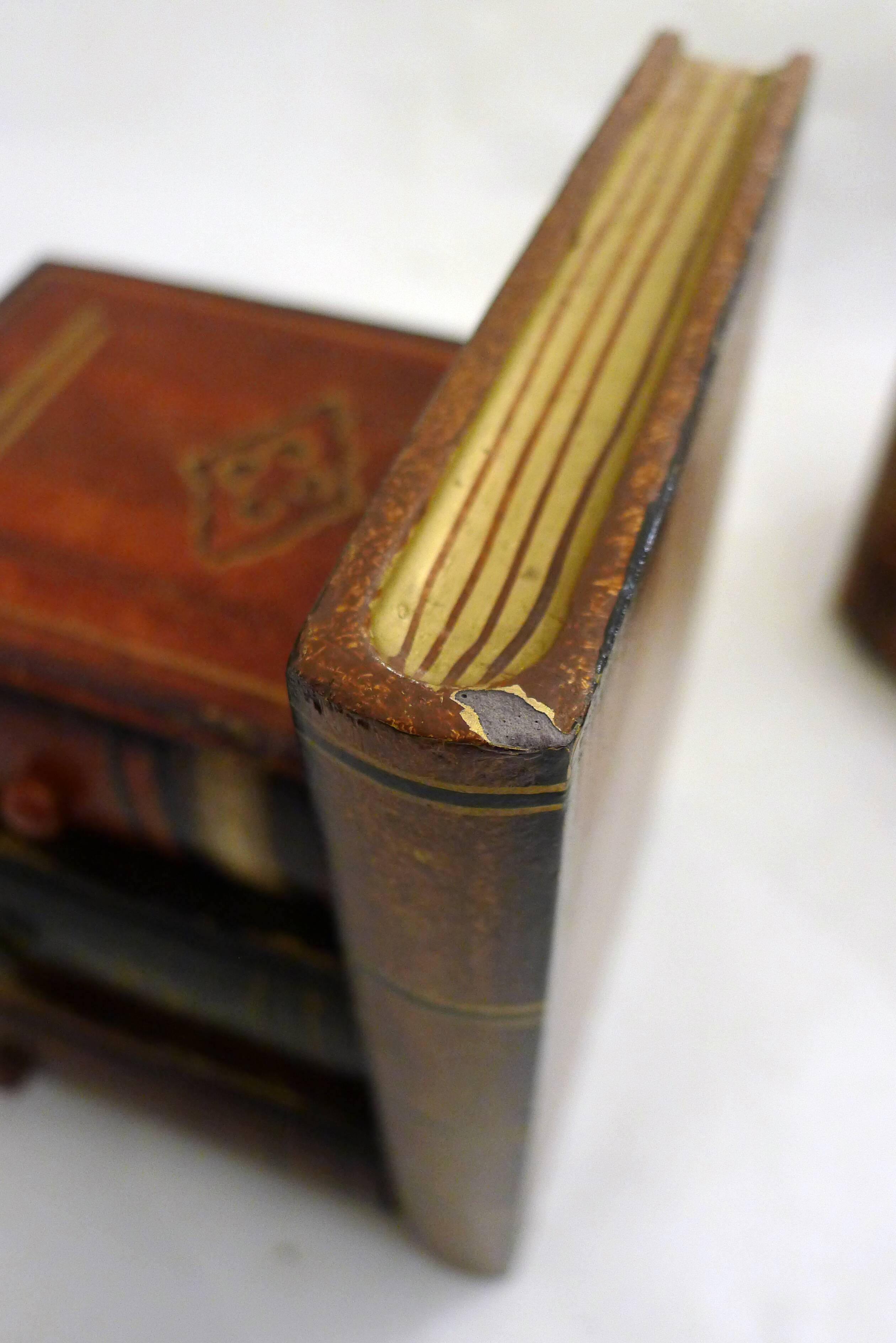 Pair of bookends (& secret boxes) in trompe l'oeil Stacked books