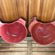 Pair of red ceramic hen dish