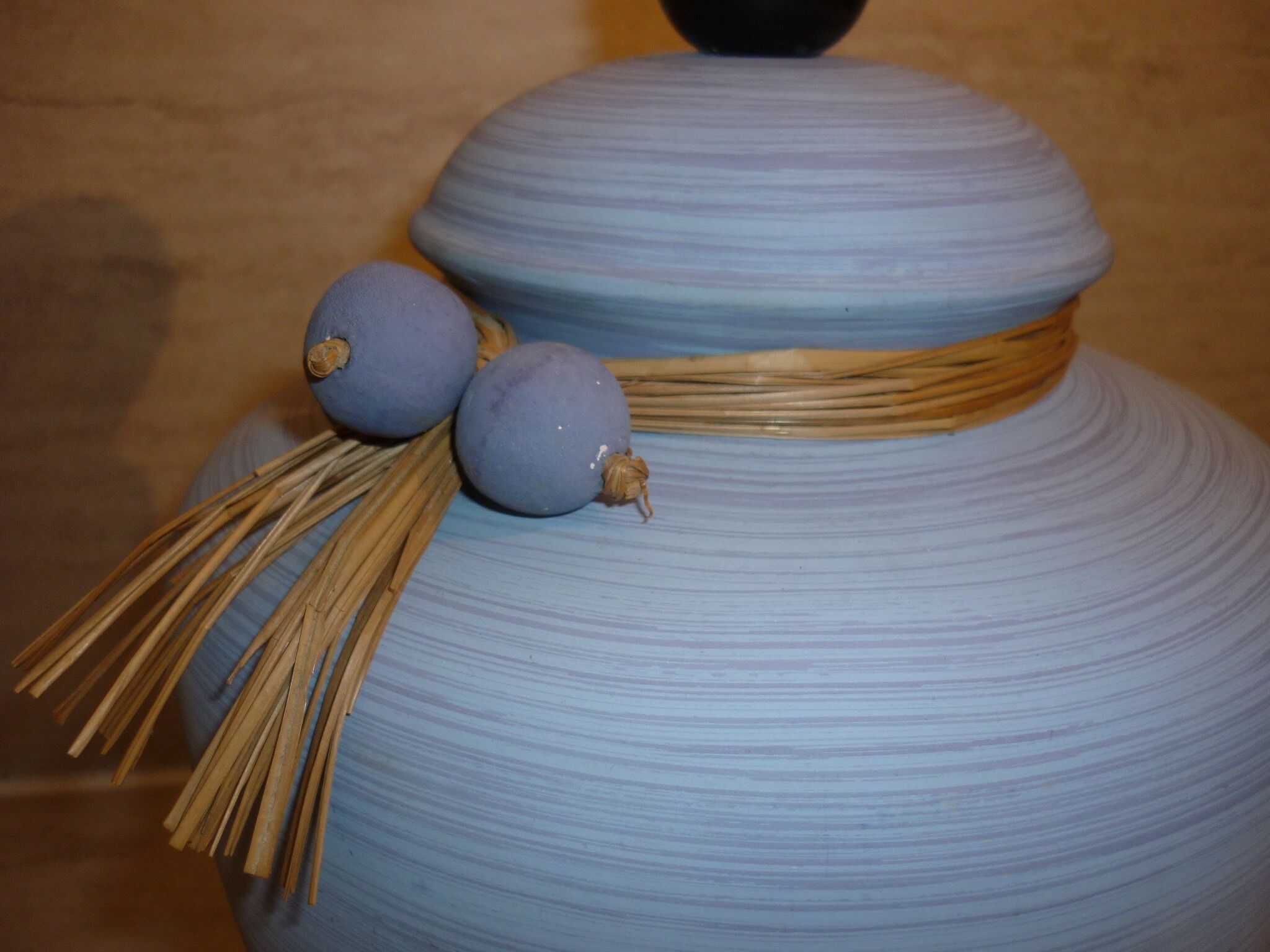 Vintage ceramic lamp foot with ball necklace and raffia.