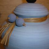 Vintage ceramic lamp foot with ball necklace and raffia.