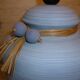 Vintage ceramic lamp foot with ball necklace and raffia.