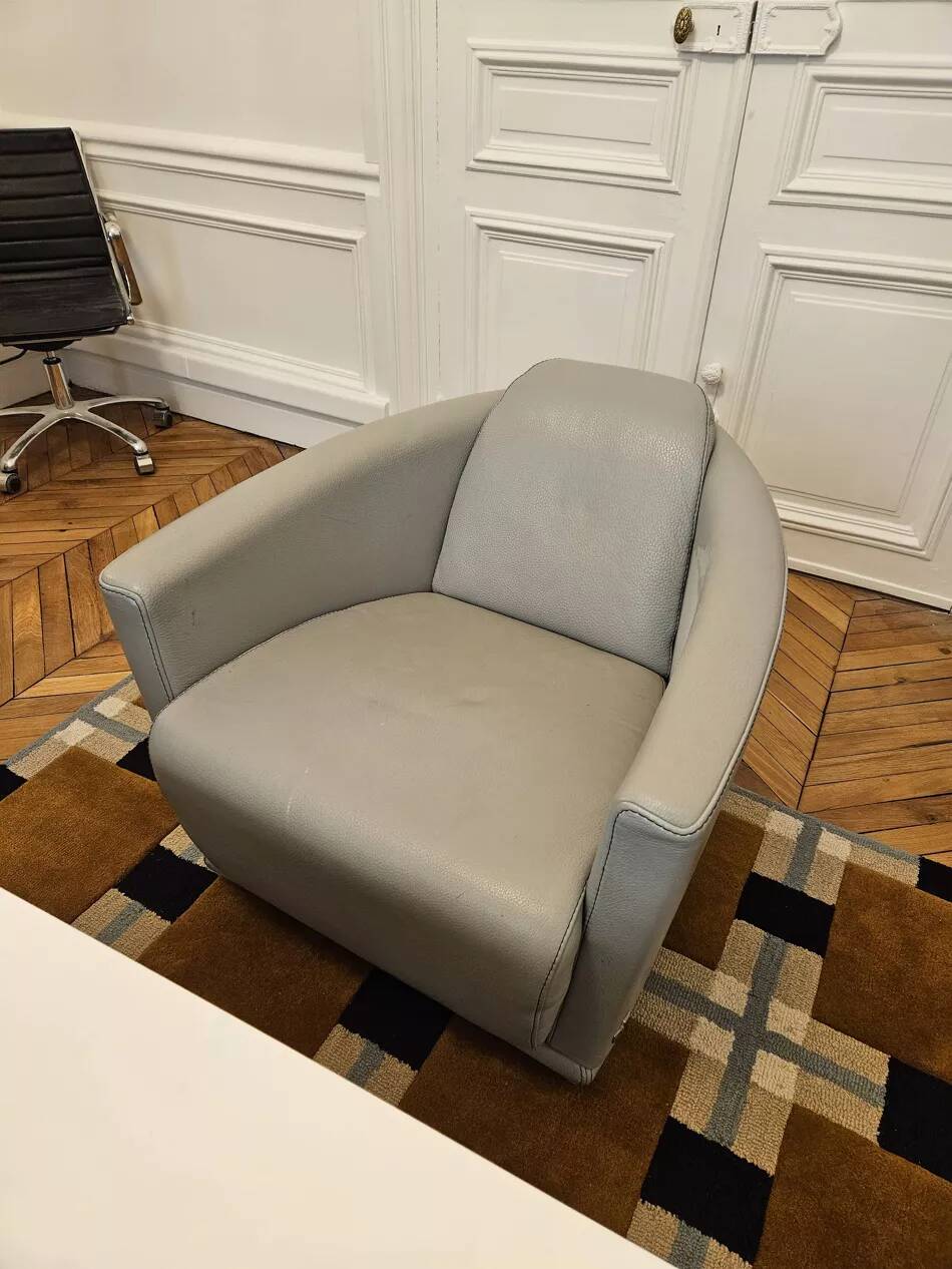 Two-seater sofa and a grey leather armchair Italia.