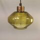 Hanging lamp with an outer shade of olive green glass and an inner shade of clear, crystal glass.