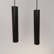Two cylinder-shaped hanging lamps in black lacquer
