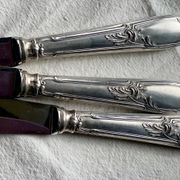 Set of 12 silver-plated metal table knives in Art Nouveau style.