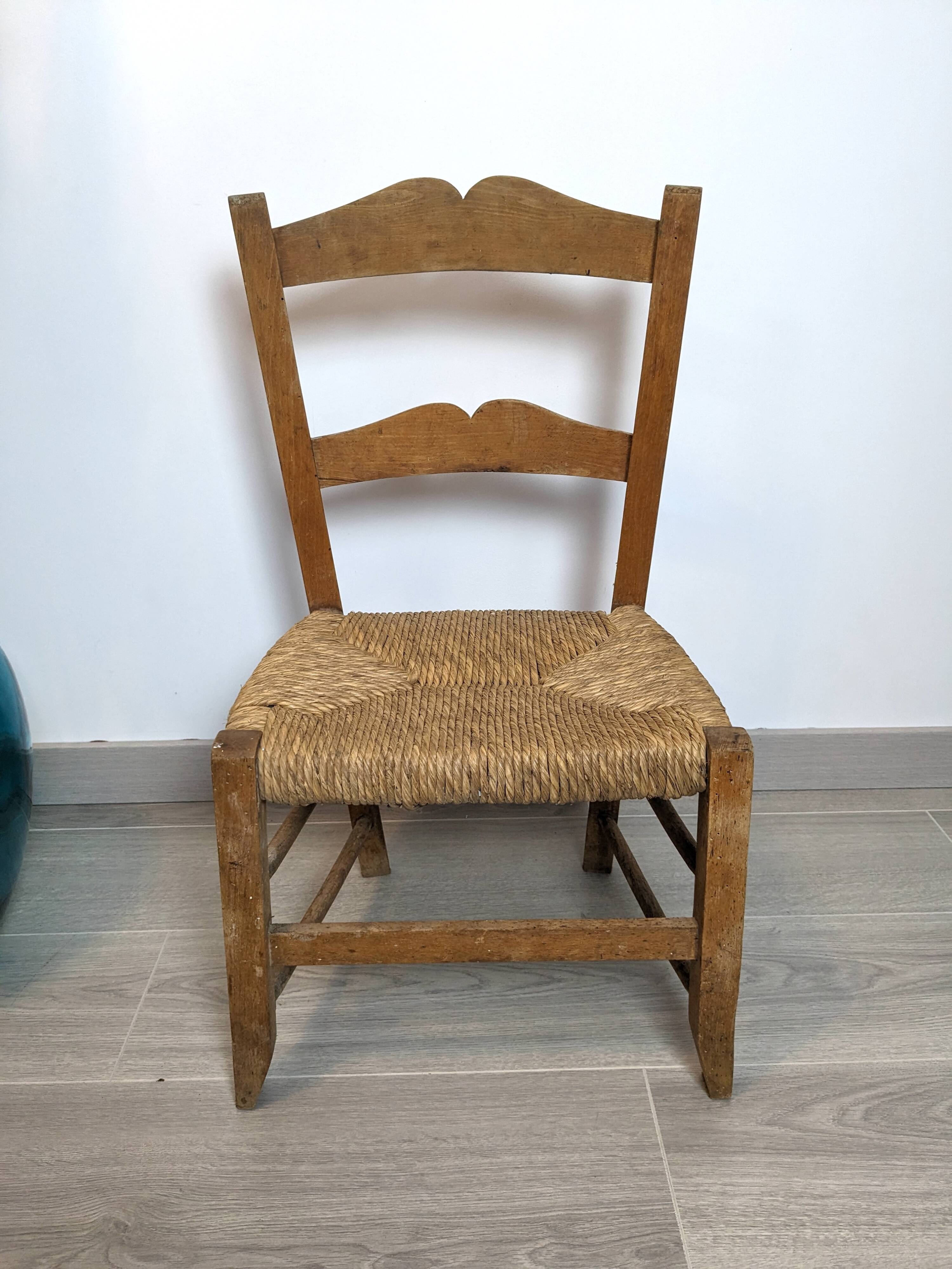 Vintage wooden and straw children's chair in a country style.