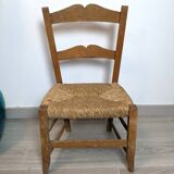 Vintage wooden and straw children's chair in a country style.