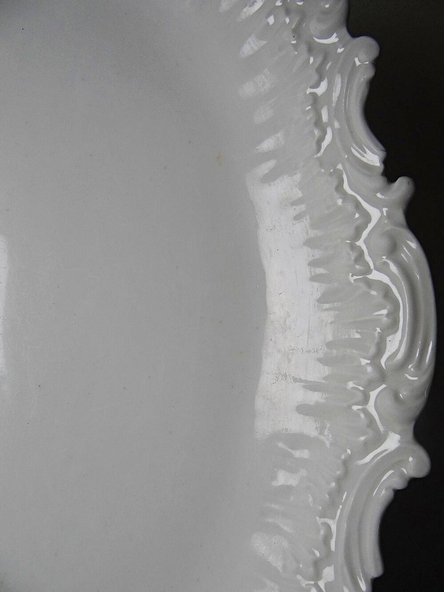 Antique deep dish in white Limoges porcelain, with rockwork relief.