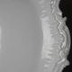 Antique deep dish in white Limoges porcelain, with rockwork relief.