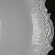 Antique deep dish in white Limoges porcelain, with rockwork relief.