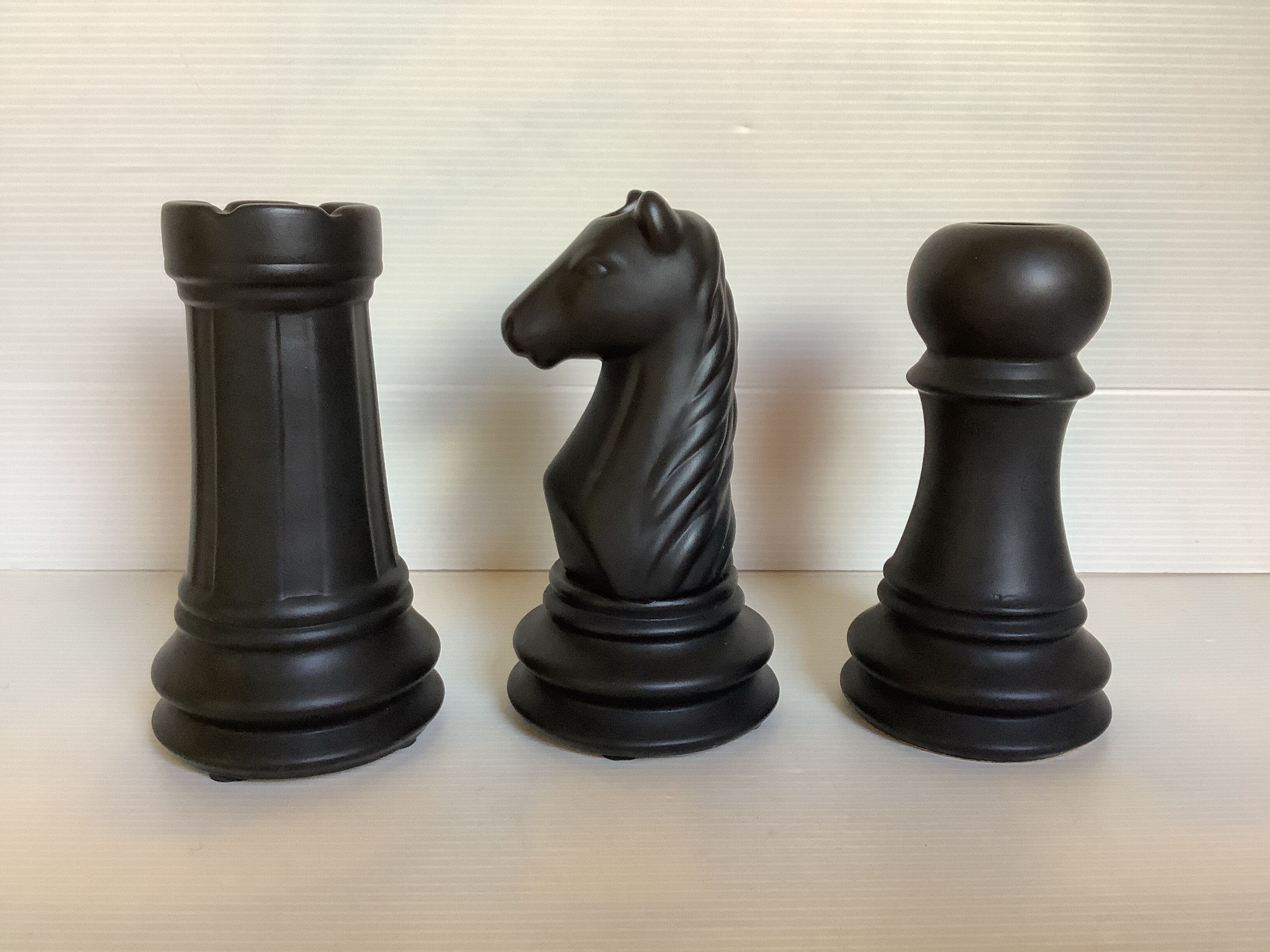 Trio of chess game candlesticks, rook, knight, pawn