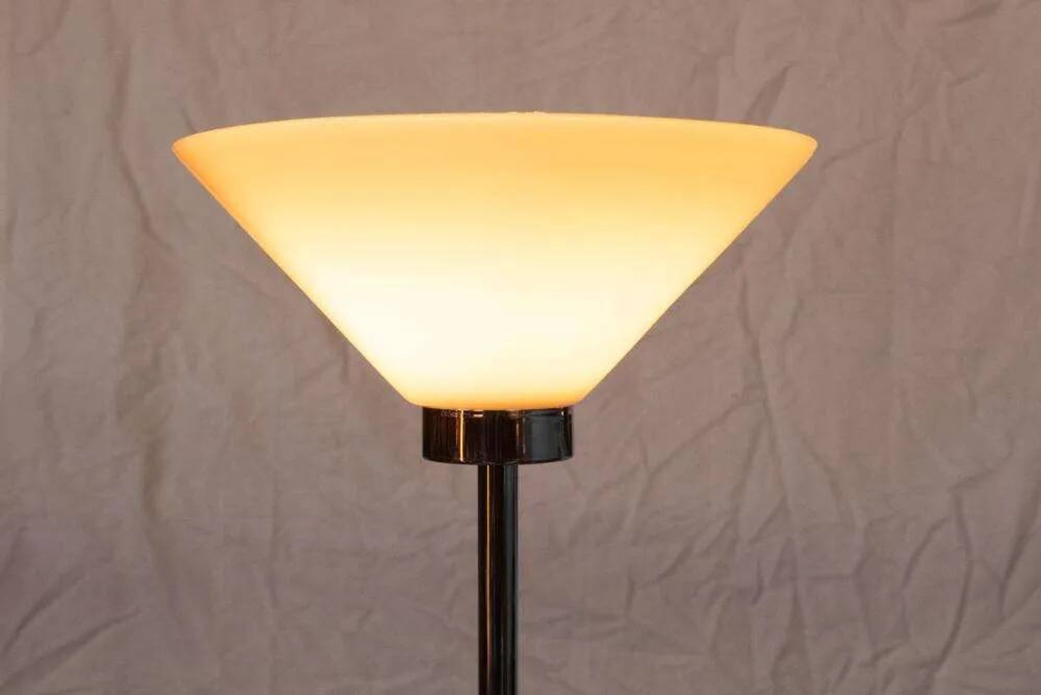 Vintage floor lamp in milky glass and chrome, minimalist uplight lighting.