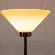 Vintage floor lamp in milky glass and chrome, minimalist uplight lighting.