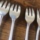 8 mismatched fish forks, silver metal
