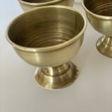 4 golden brass egg cups