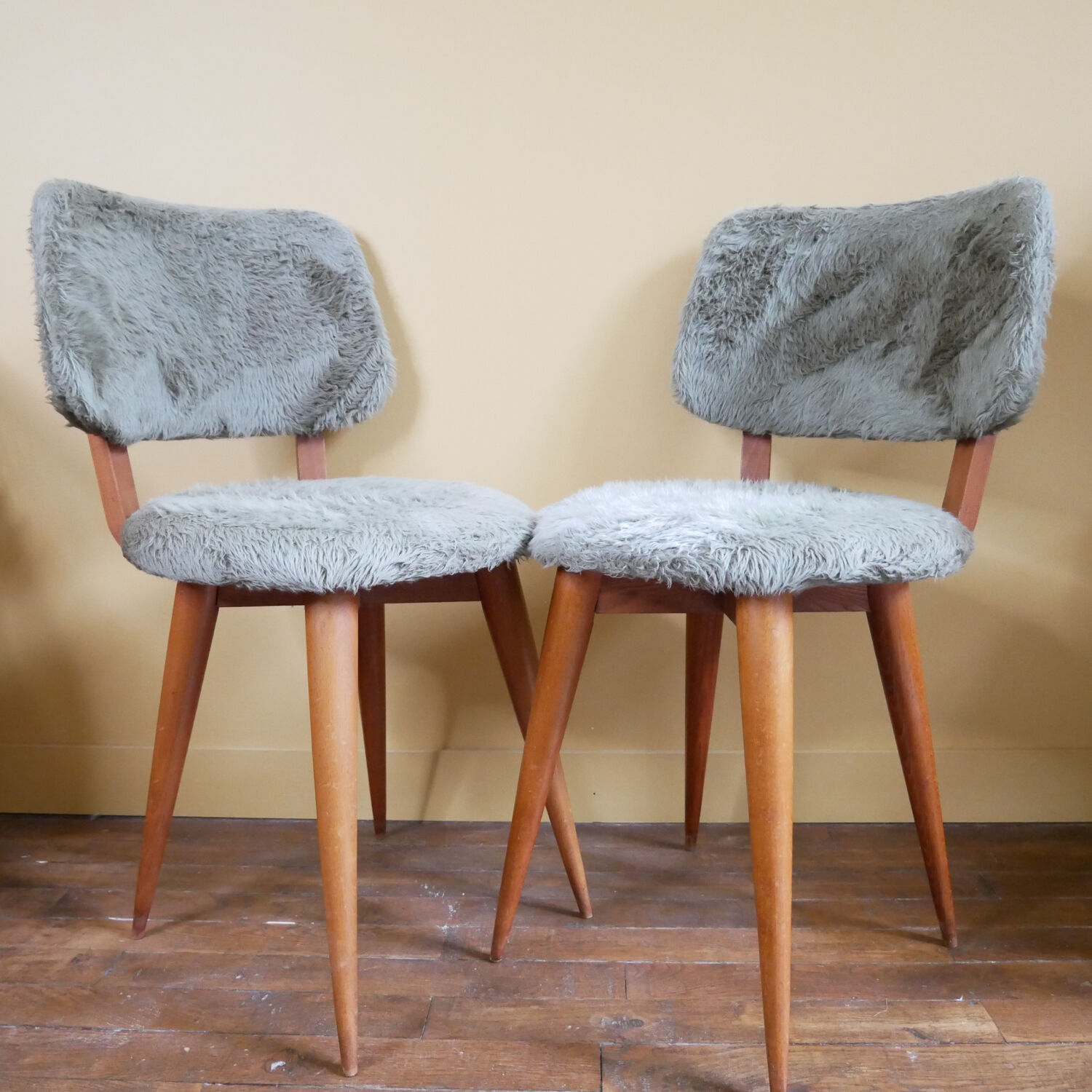 Pair of moumoute chairs with compass feet