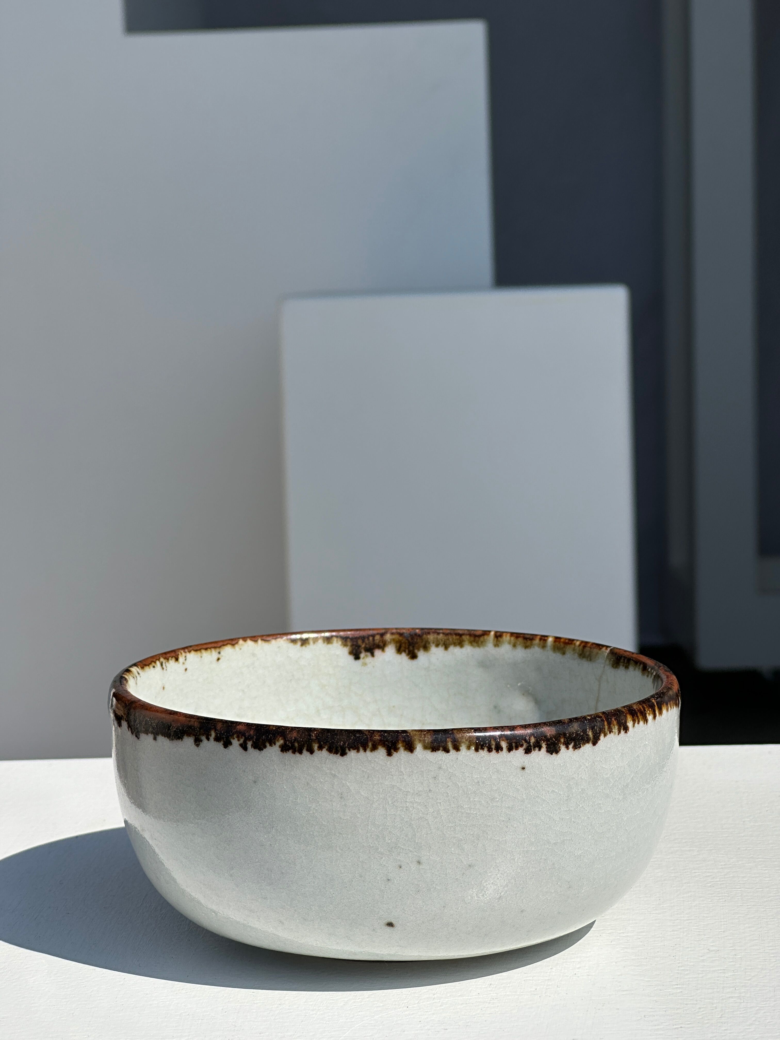 Small white glazed ceramic bowl black edges