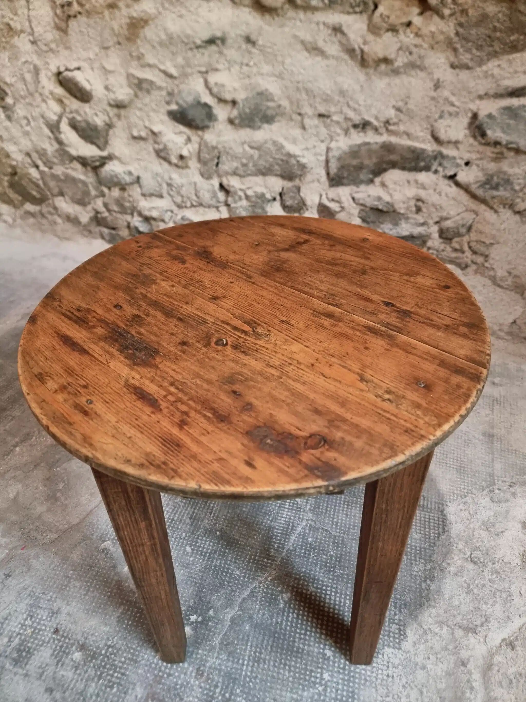 Antique round side table with oak legs and a pine top, circa 1900.