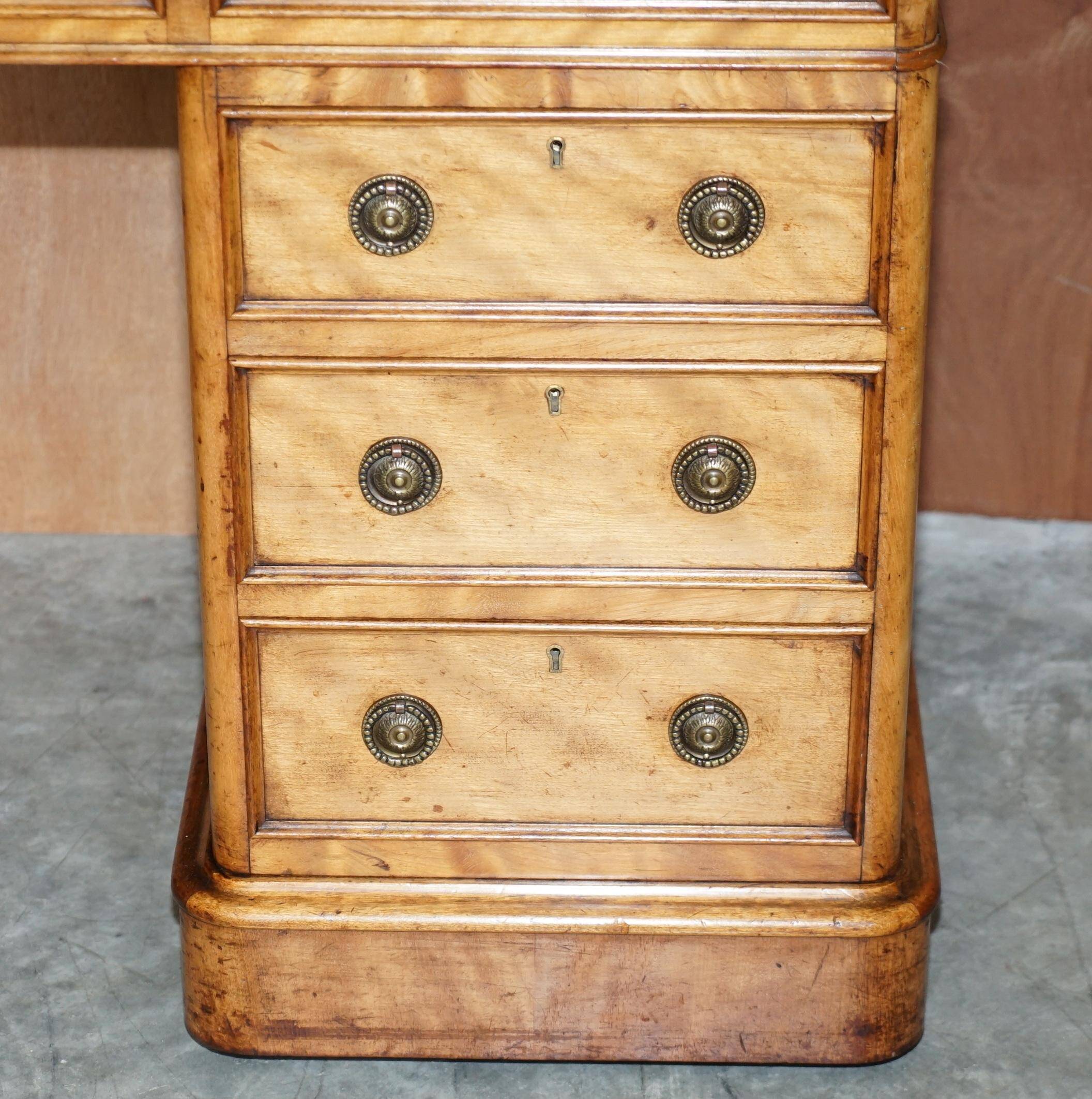 Antique desk by James Winter & Sons London in satin wood and leather.