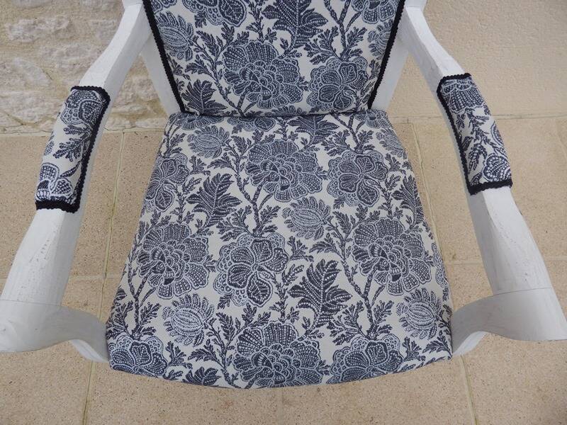 Voltaire style armchair covered in floral fabric in quality aged wood