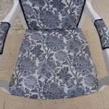 Voltaire style armchair covered in floral fabric in quality aged wood