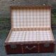 Old trunk, travel suitcase, with carrying handles and interior lockers, wooden reinforcements
