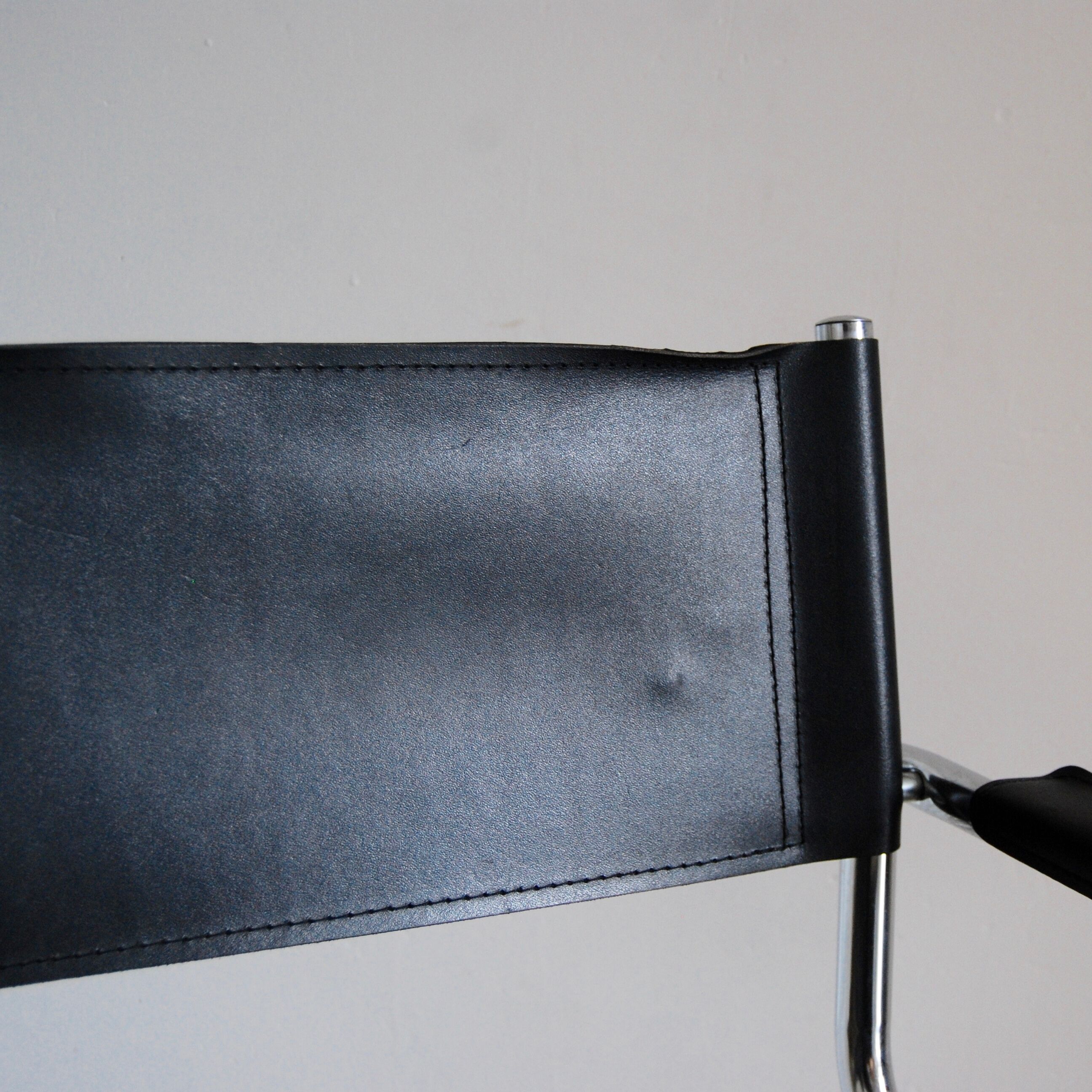 Vintage chrome and faux black leather armchair