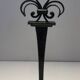 Important pair of wrought iron andirons with torch in heraldic fleur-de-lis design.