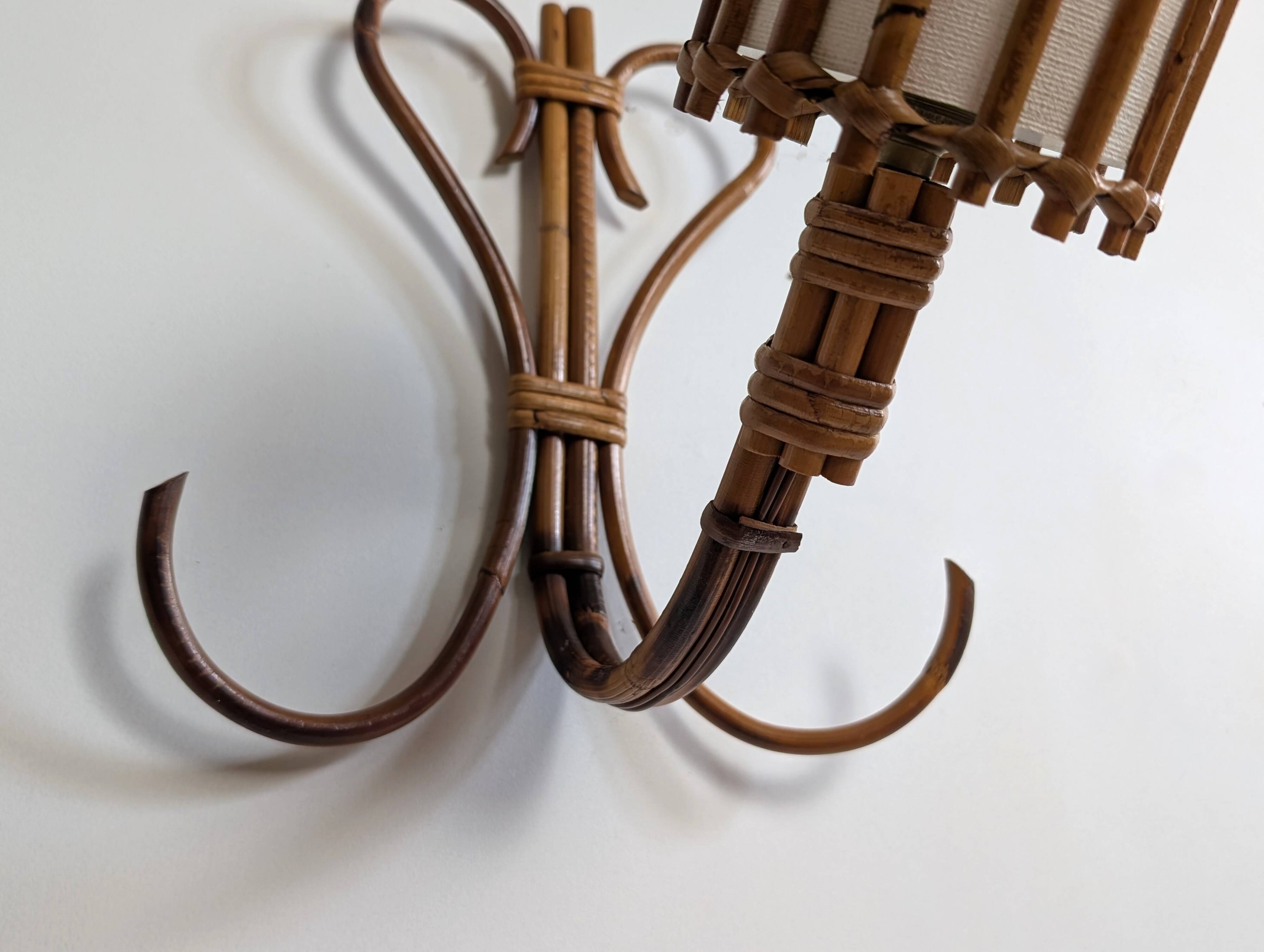 Rattan wall lights by Louis Sognot