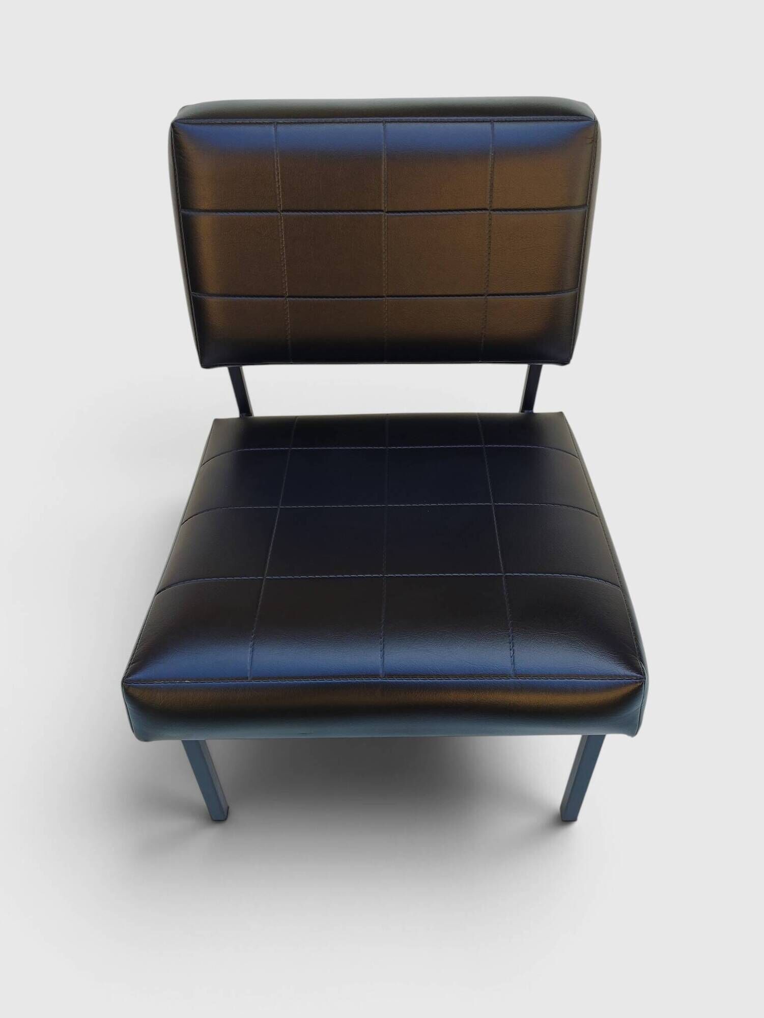 Modernist armchair in black faux leather and metal – 1960s