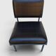 Modernist armchair in black faux leather and metal – 1960s