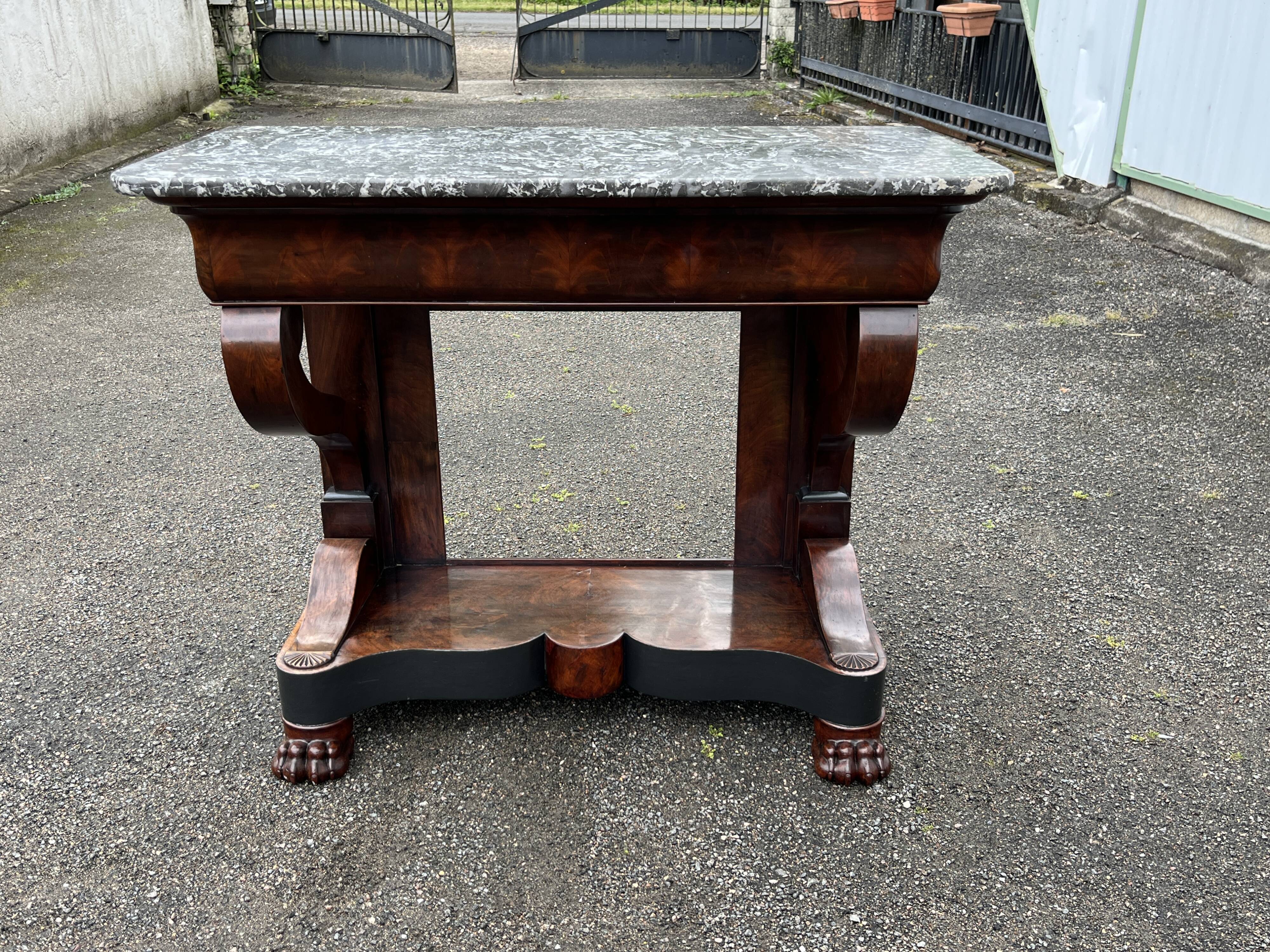 Mahogany console with grey marble top and lion paw feet.