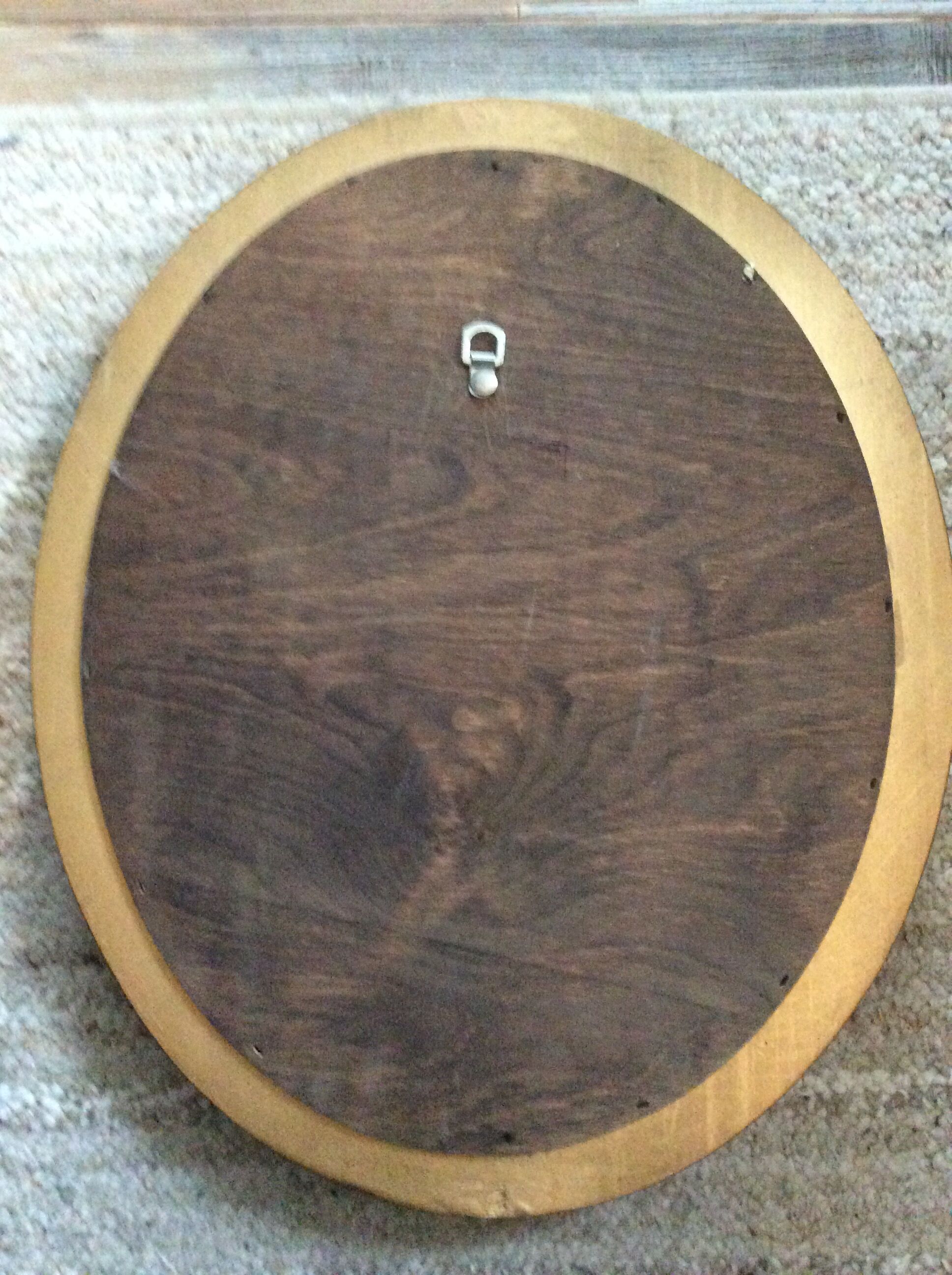 Old oval mirror in gilded wood