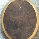 Old oval mirror in gilded wood