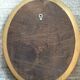 Old oval mirror in gilded wood