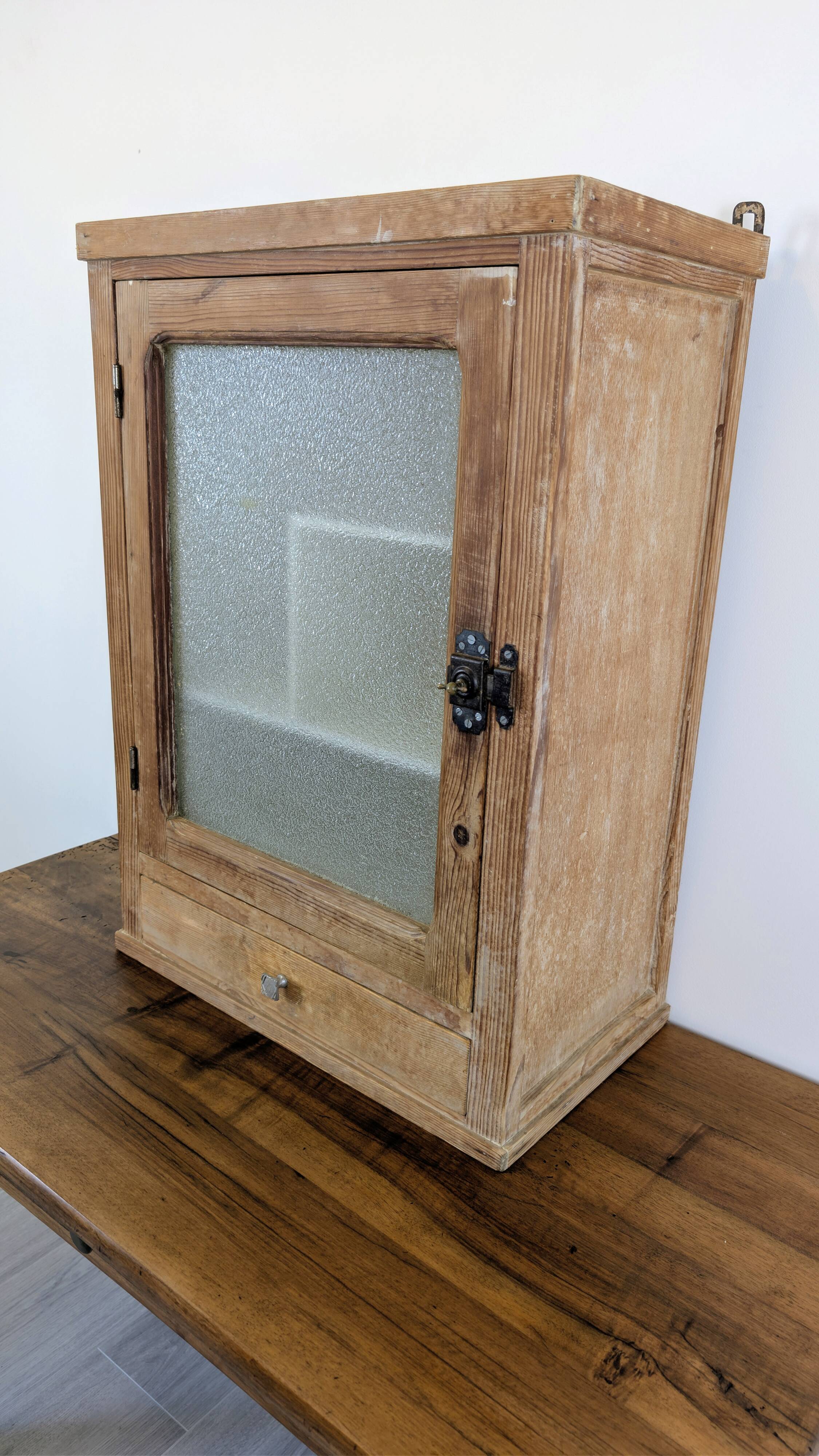 Small glass wall cabinet from the 1960s.