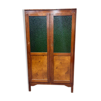 Vintage wooden display cabinet with green glass.
