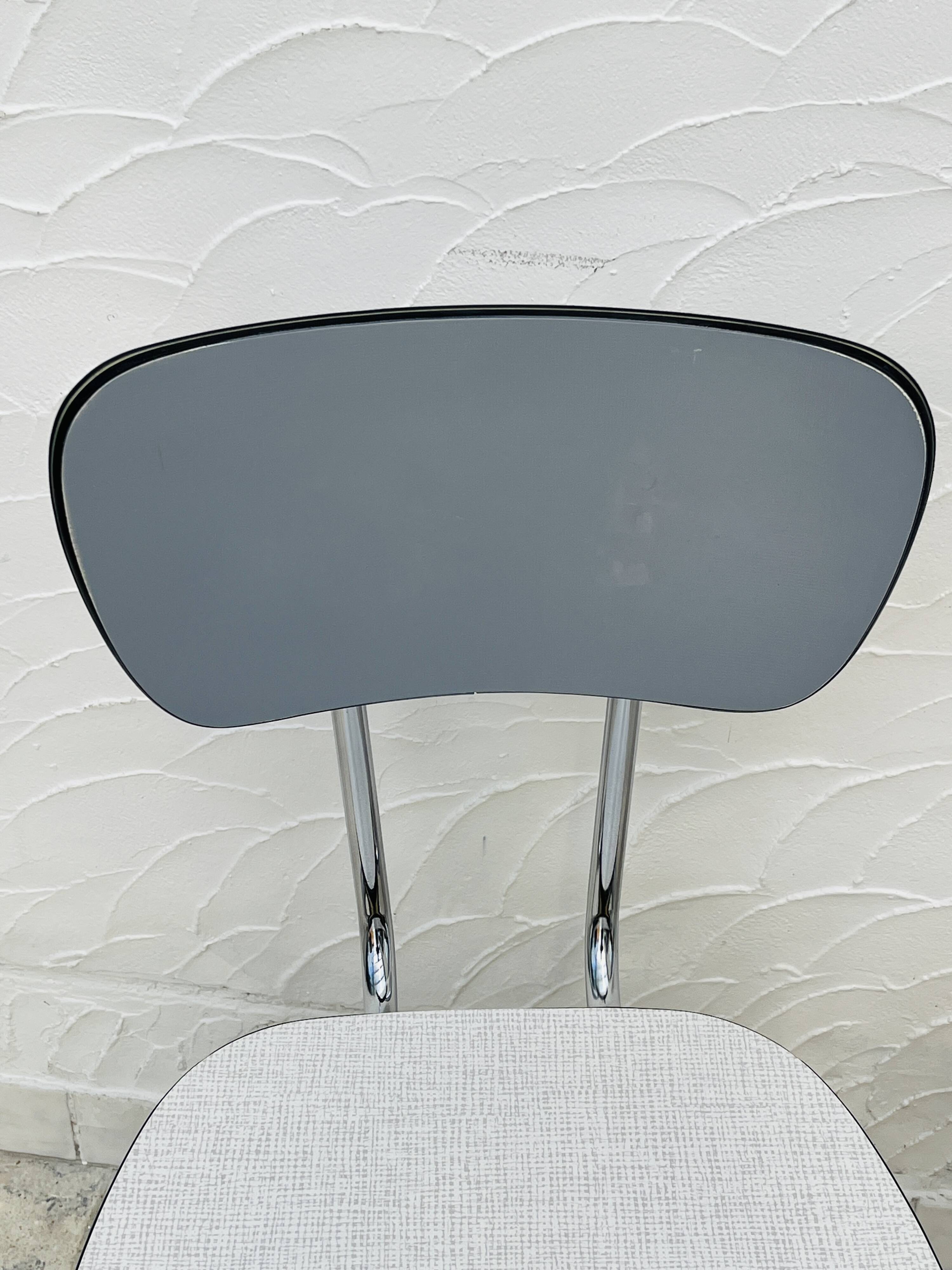 Set of two vintage grey Formica and chrome chairs.
