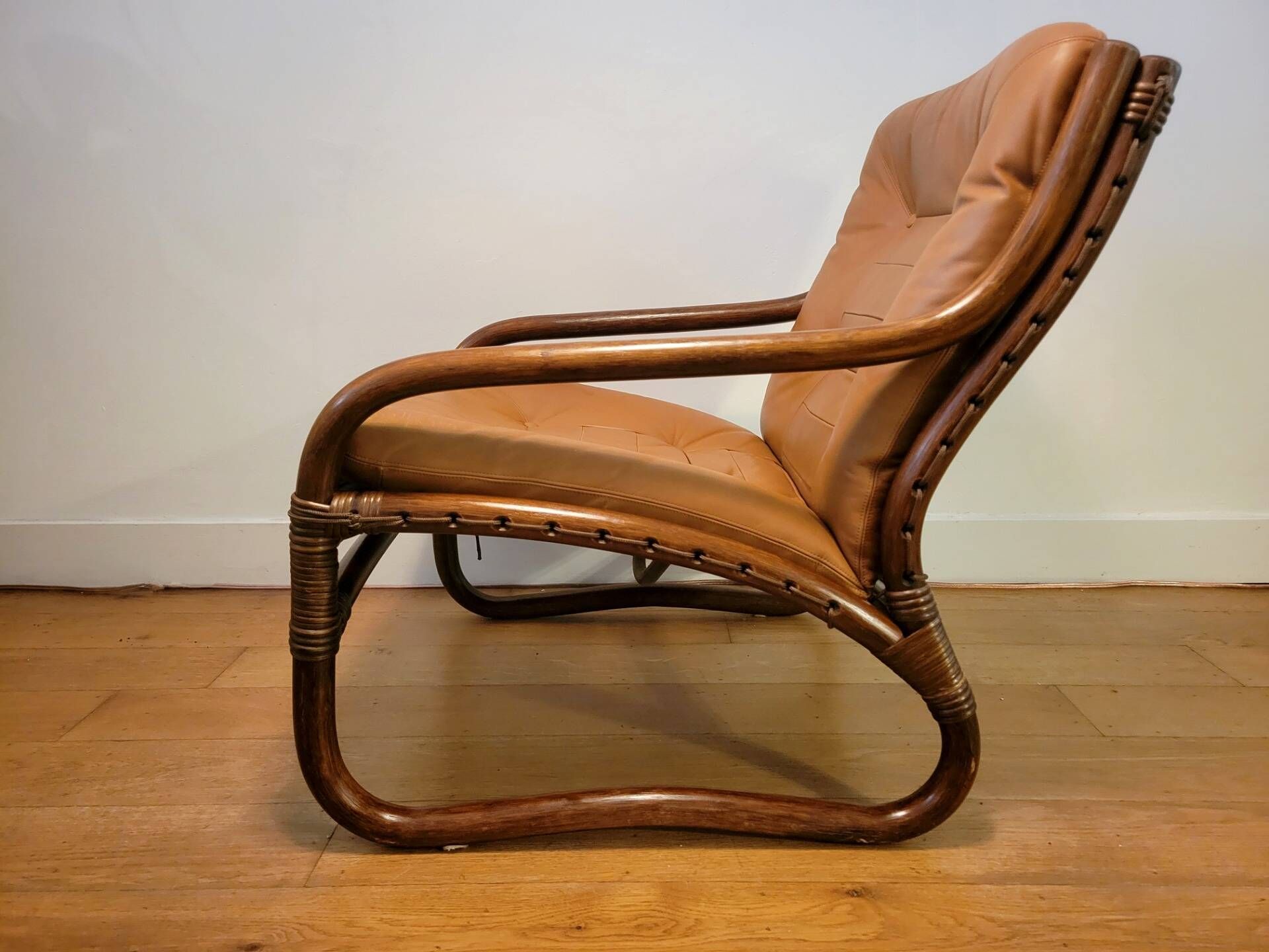 Vintage rattan armchair with leather cushions from 1970