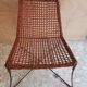 Modernist armchair in woven leather and black metal – 1960s–1970s