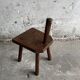 Dark brown solid oak brutalist stool with sculptural backrest, handcrafted mid-century rustic primitive