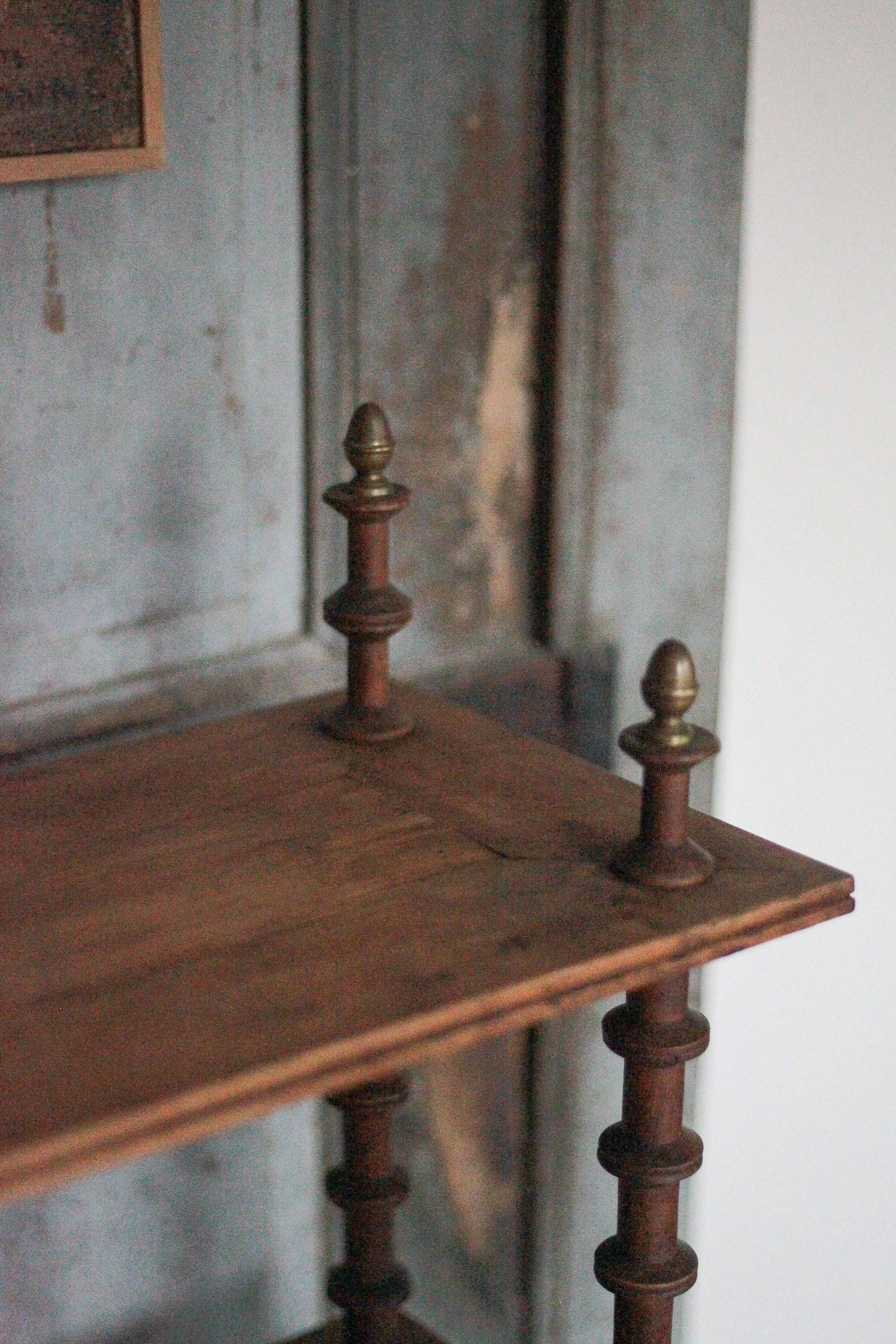 Napoleon III spool shelf, floor-standing shelf with brass tips.